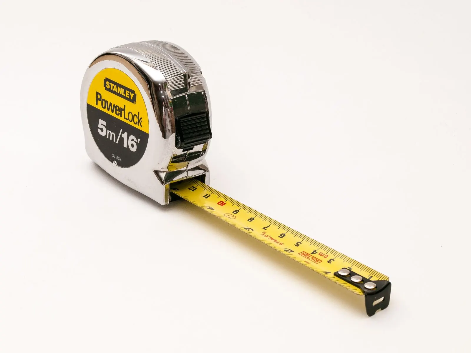 A tape measure with its yellow blade extended, on a white background